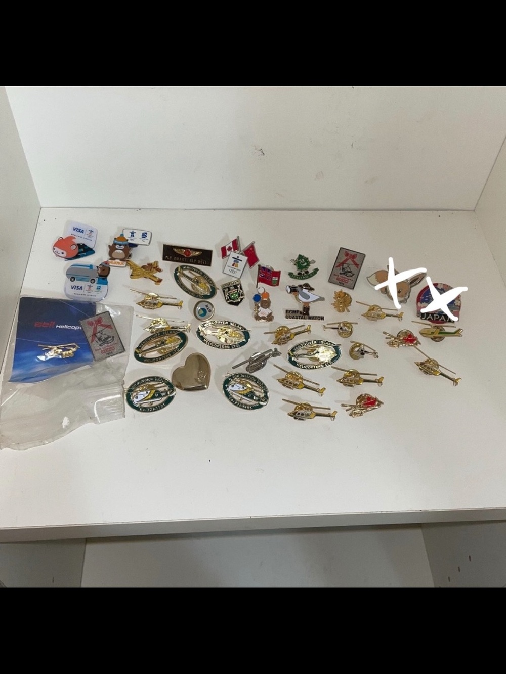 Collection of helicopter and olympics pins